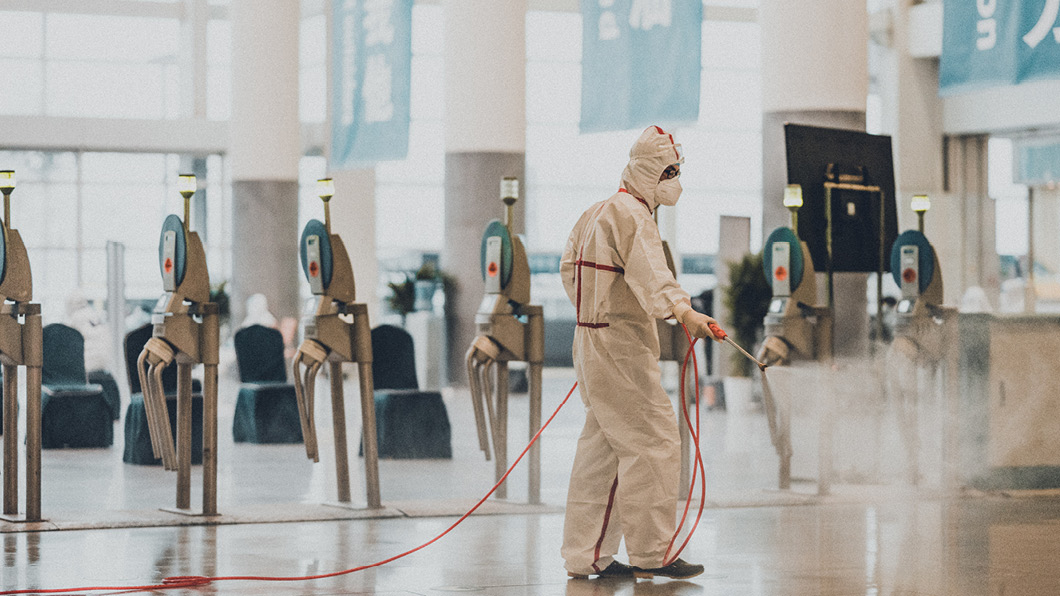 Man disinfects floor against coronavirus